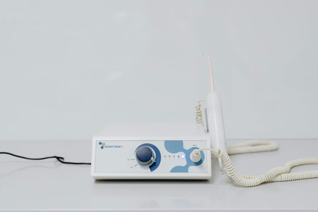 A high-tech ozone therapy device with a minimalistic design on a white backgroun