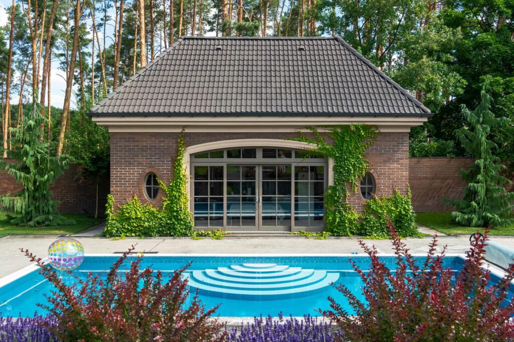 A serene garden with a modern shed and a pool, perfect for summer relaxation.