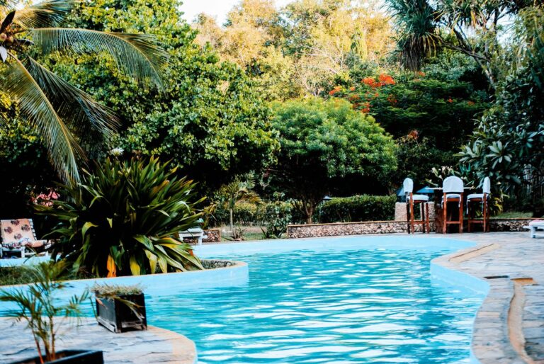 A serene poolside oasis surrounded by lush greenery, perfect for relaxation and