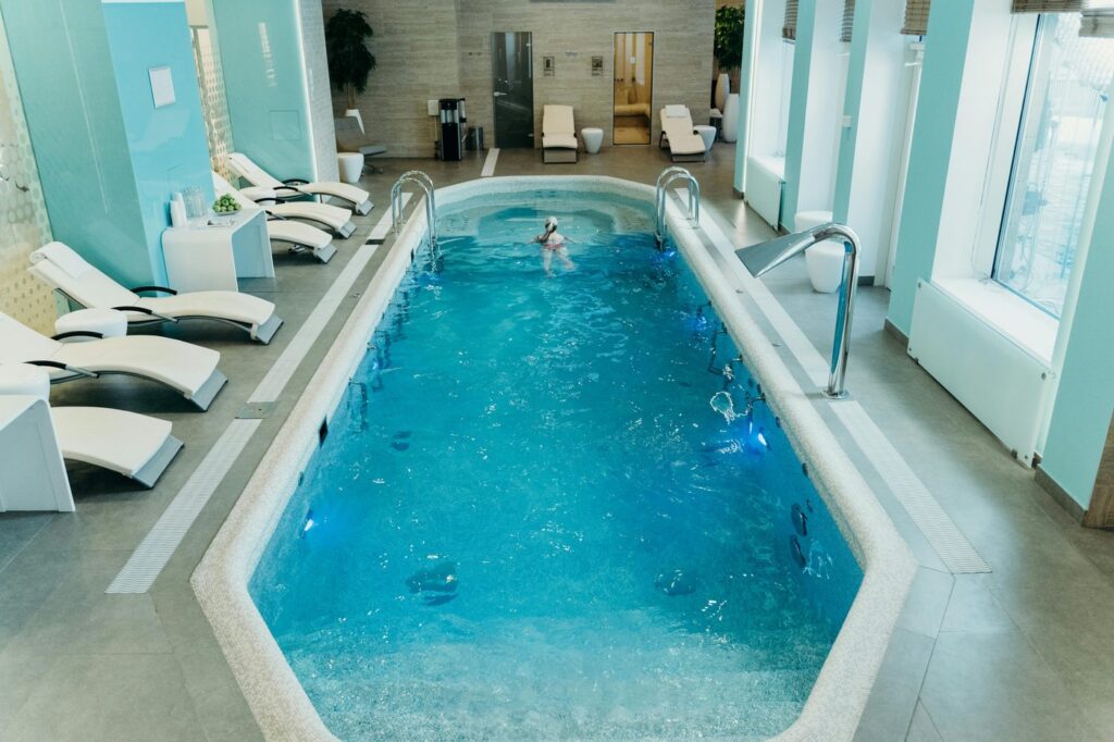 Bright indoor spa pool with lounge chairs and calm atmosphere, ideal for relaxat