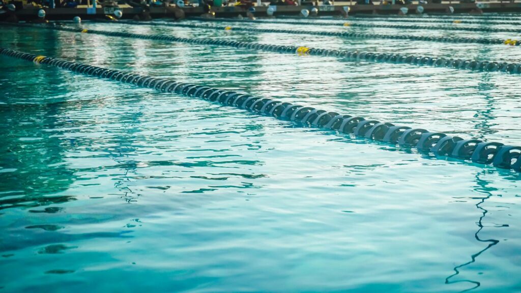 Calm and inviting outdoor swimming pool with blue water and lane dividers.