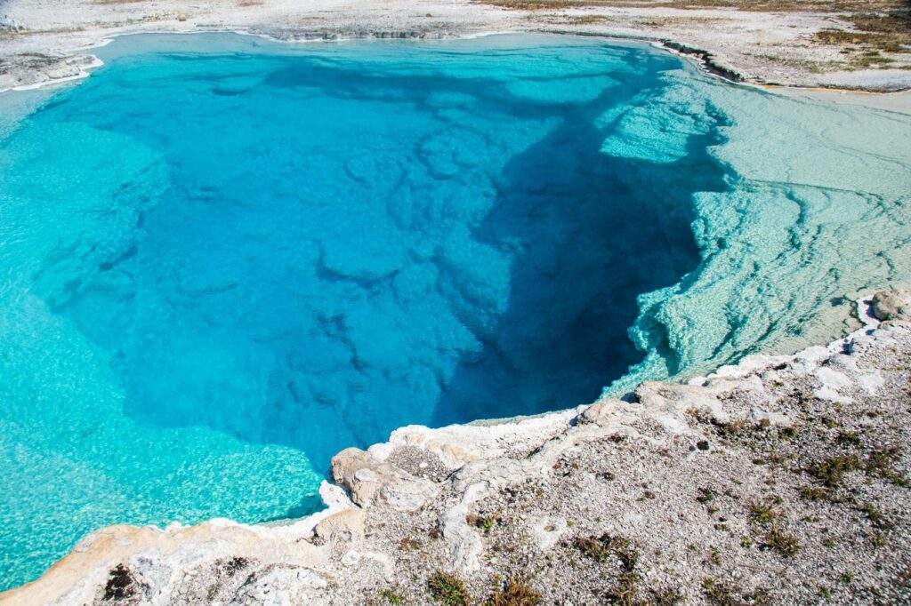 Stunning view of a vibrant blue geothermal spring in Yellowstone National Park.